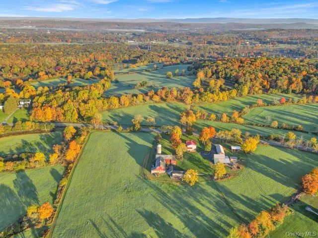 an aerial view of a houses with a yard
