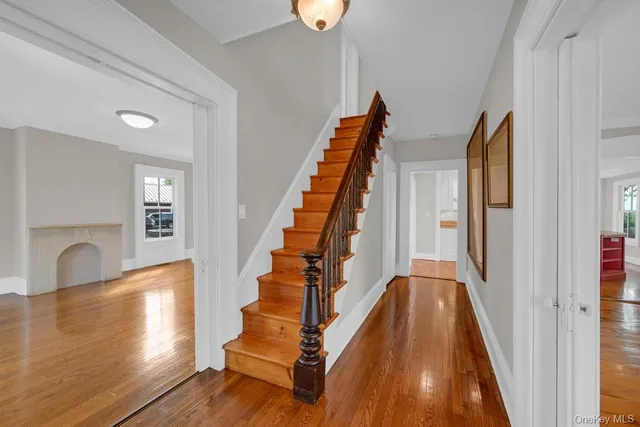 a view of entryway and hall with wooden floor