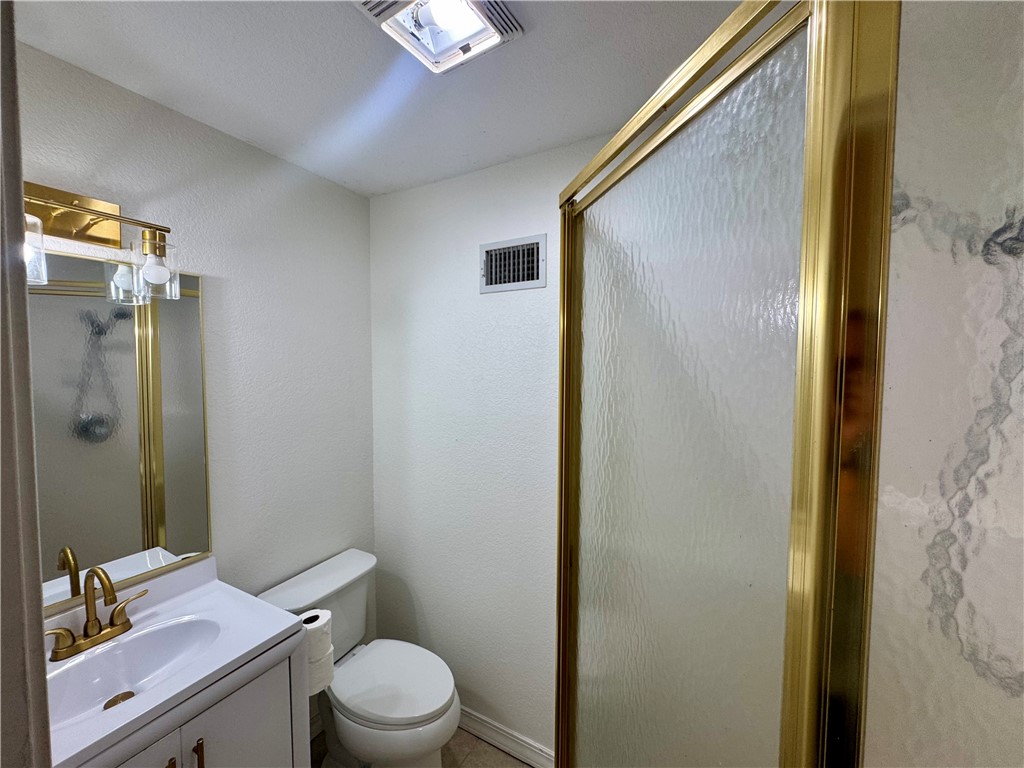 1197 Ridgeview Lane Russellville, AR 72802 - Photo 13 of 44 Efficiently designed half bath featuring a white ceramic pedestal sink with brass-finish faucet, white porcelain toilet, and framed mirror with brass trim