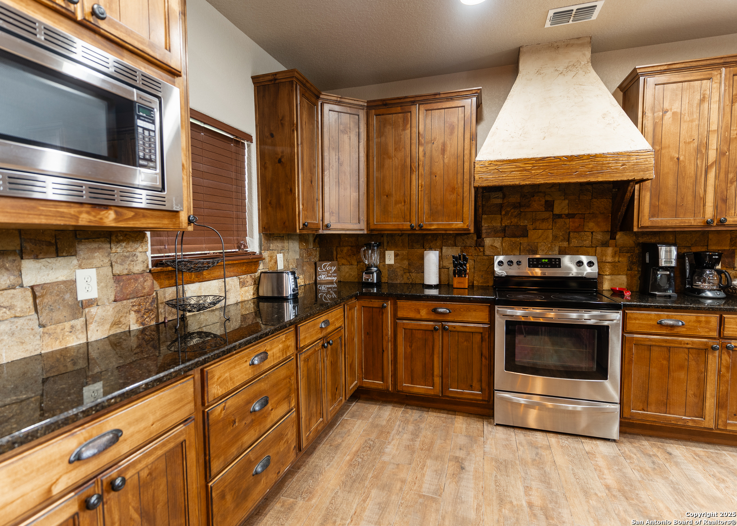 24 Morning Dew Concan, TX 78838 - Photo 13 of 88 a kitchen with stainless steel appliances granite countertop a stove a sink and a microwave