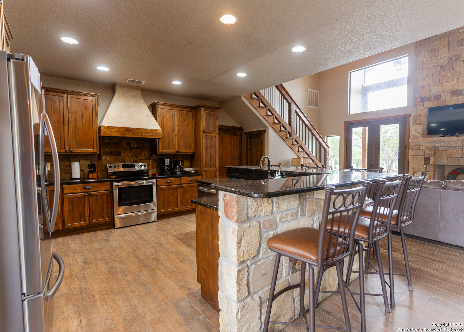 24 Morning Dew Concan, TX 78838 - Photo 14 of 88 a kitchen with stainless steel appliances kitchen island granite countertop a refrigerator a stove a sink a dining table and chairs