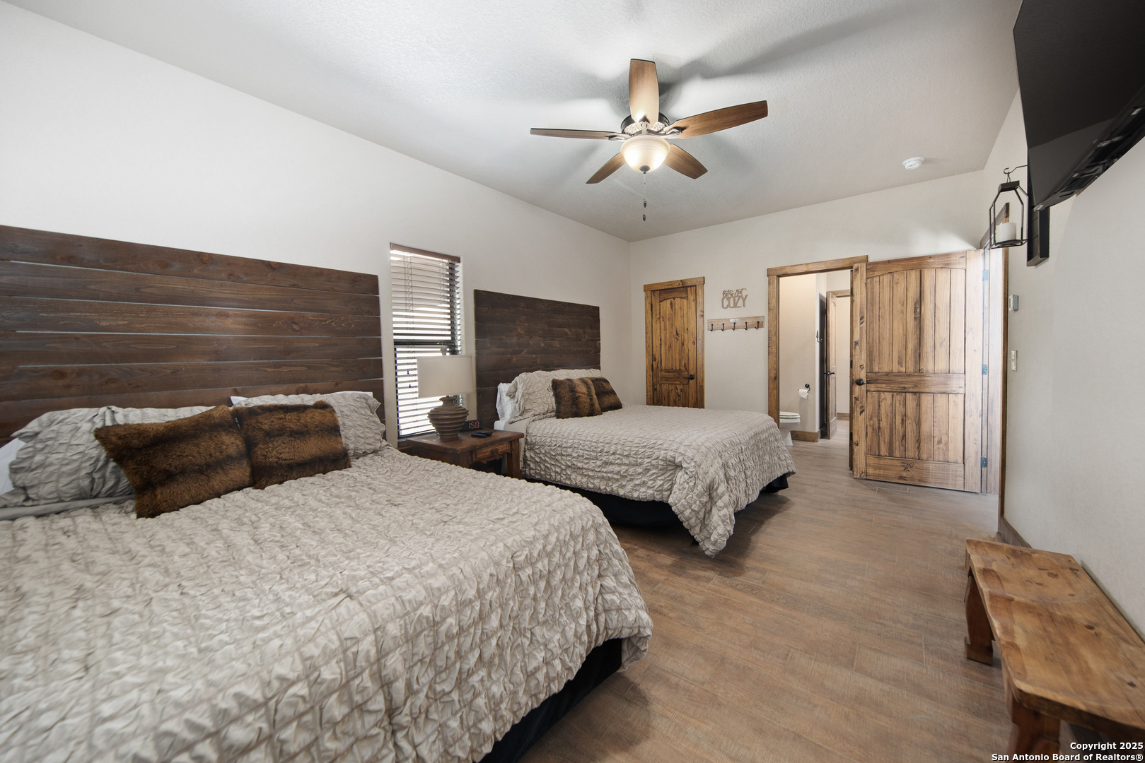 24 Morning Dew Concan, TX 78838 - Photo 18 of 88 a bedroom with two beds and a chandelier