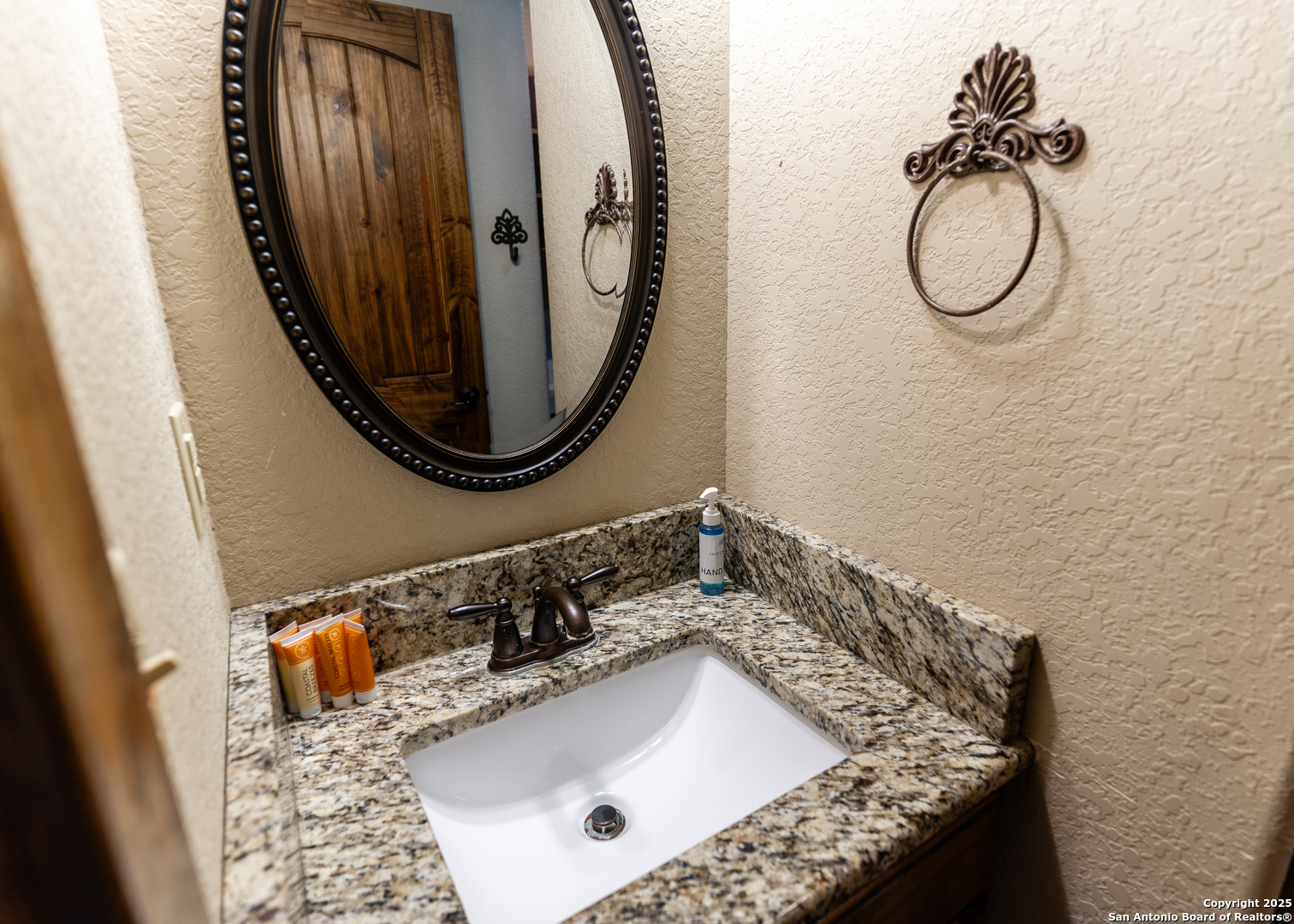 24 Morning Dew Concan, TX 78838 - Photo 28 of 88 a bathroom with a granite countertop sink and a mirror