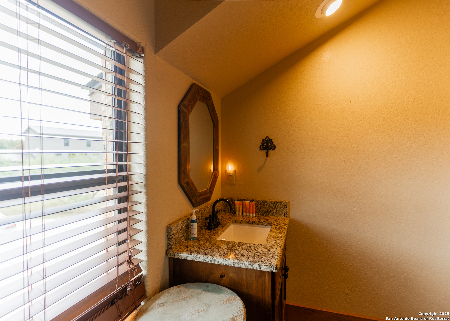 24 Morning Dew Concan, TX 78838 - Photo 29 of 88 a bathroom with a granite countertop sink and a mirror
