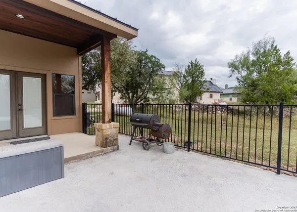 a kitchen with stainless steel appliances kitchen island granite countertop a table chairs in it and wooden floors