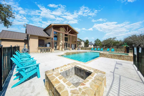 a kitchen with stainless steel appliances granite countertop wooden cabinets a sink dishwasher a stove and a refrigerator