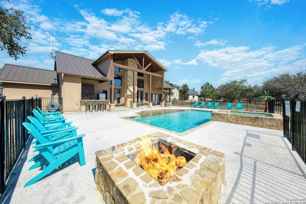 a kitchen with stainless steel appliances kitchen island granite countertop a dining table chairs and granite counter tops