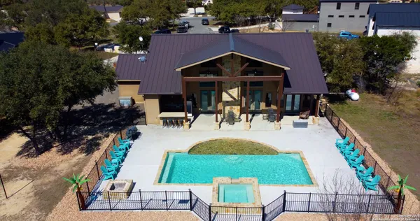 an aerial view of a house with a garden and lake view