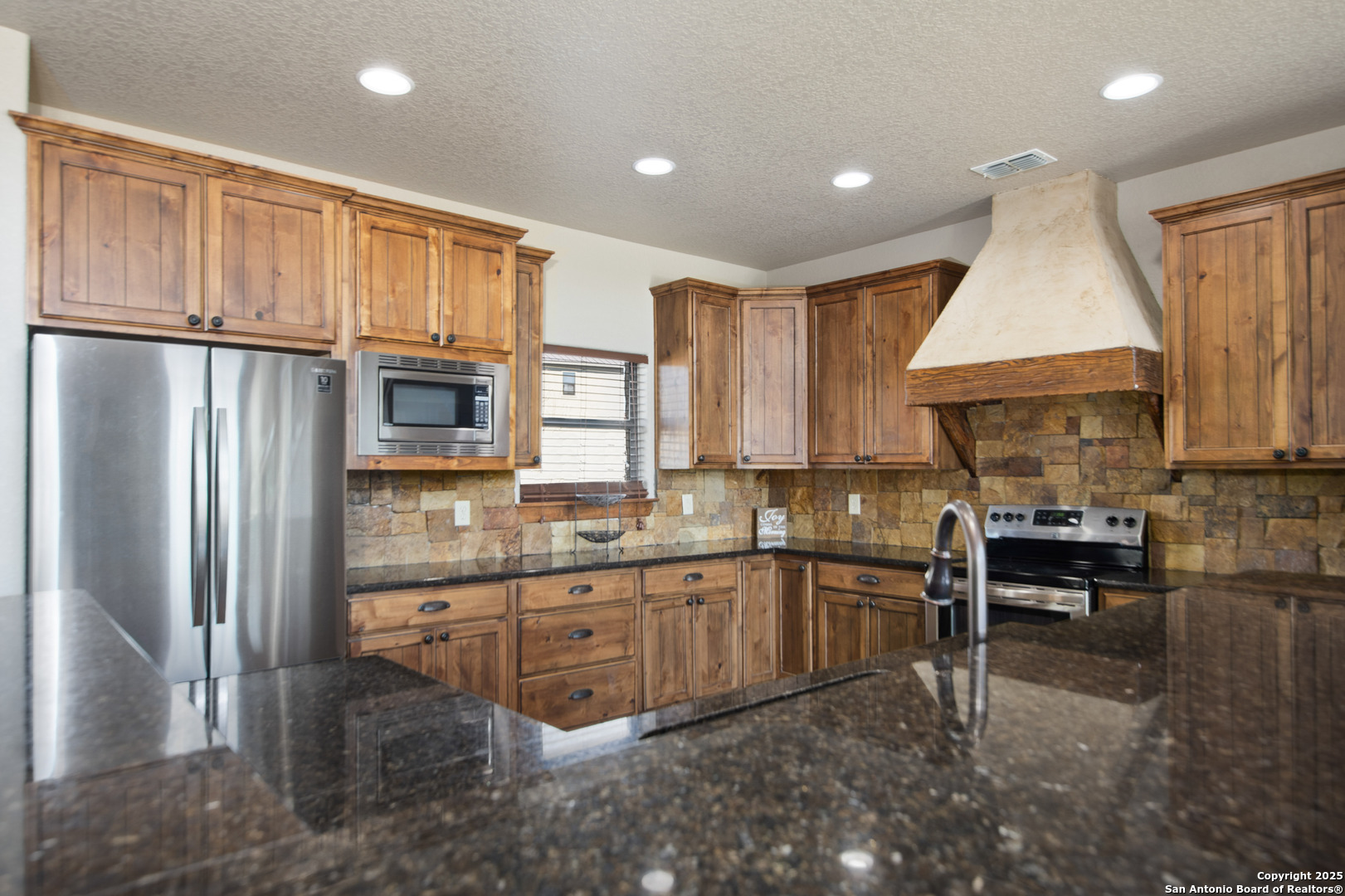 24 Morning Dew Concan, TX 78838 - Photo 69 of 88 a kitchen with stainless steel appliances granite countertop a refrigerator sink and cabinets
