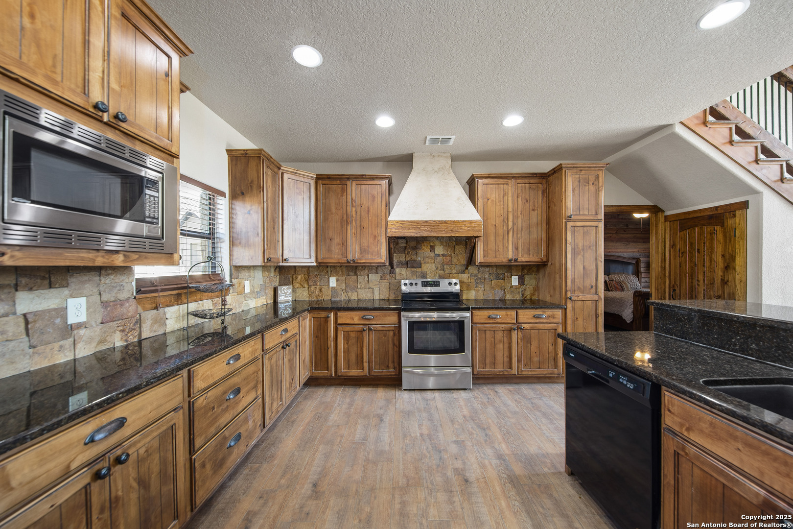 24 Morning Dew Concan, TX 78838 - Photo 72 of 88 a kitchen with stainless steel appliances granite countertop wooden cabinets a sink dishwasher a stove and a refrigerator