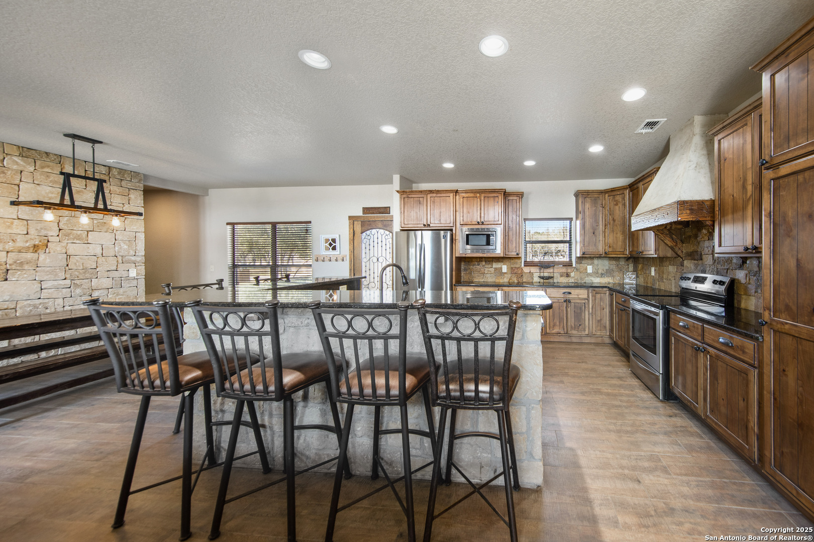 24 Morning Dew Concan, TX 78838 - Photo 74 of 88 a kitchen with stainless steel appliances kitchen island granite countertop a dining table chairs and granite counter tops
