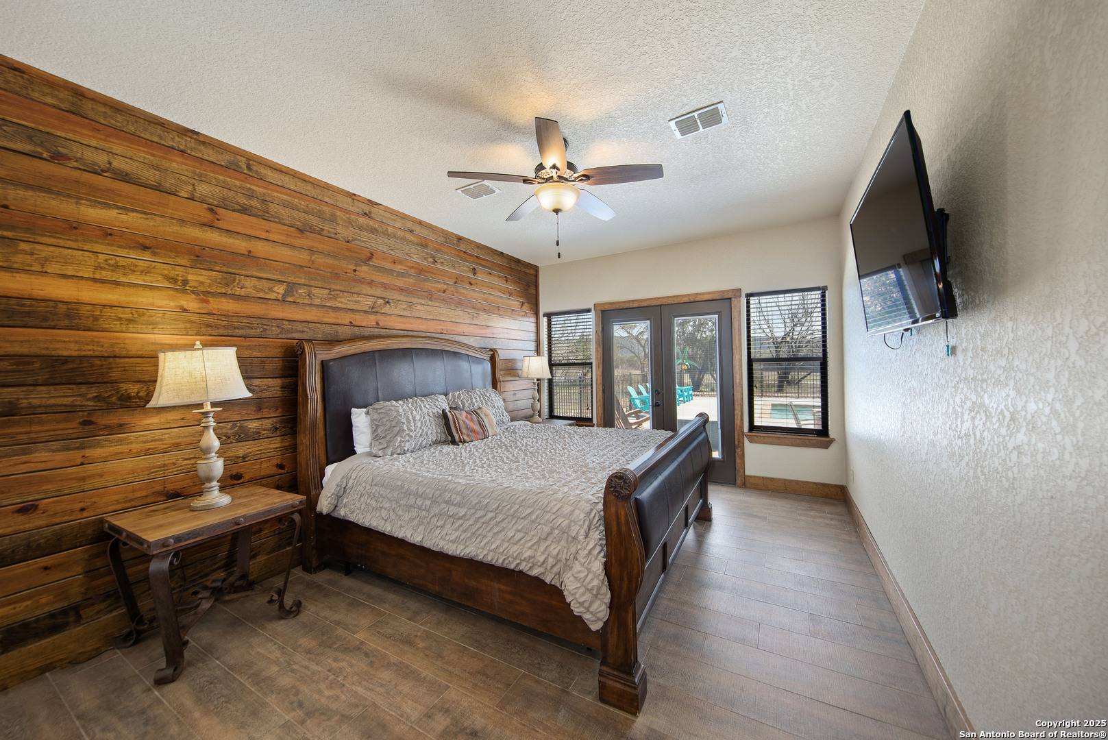 24 Morning Dew Concan, TX 78838 - Photo 80 of 88 a bedroom with a bed a flat screen tv and a chandelier