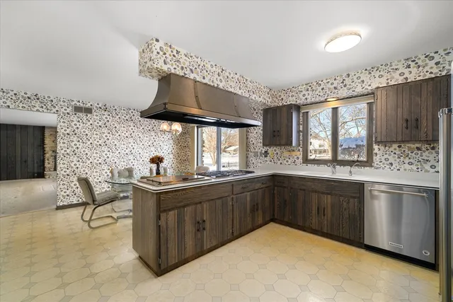 a kitchen with stainless steel appliances granite countertop a sink and cabinets