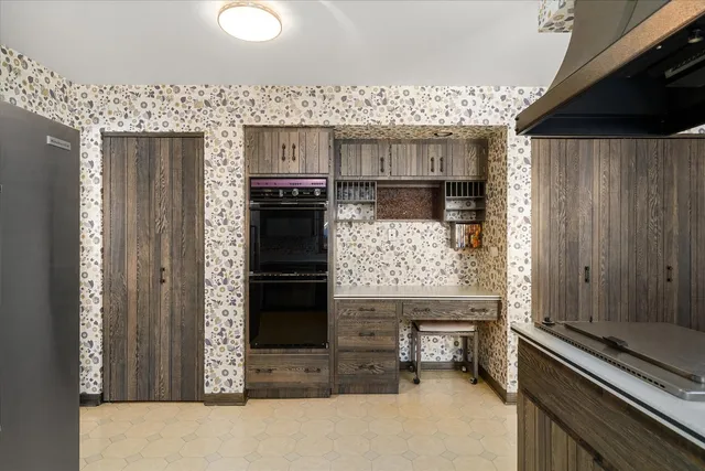 a kitchen with stainless steel appliances granite countertop a refrigerator and a stove