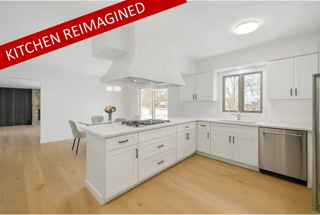 a kitchen with granite countertop a sink cabinets and window
