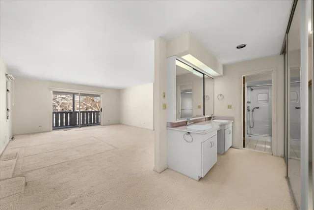 a large white kitchen with a stove top oven