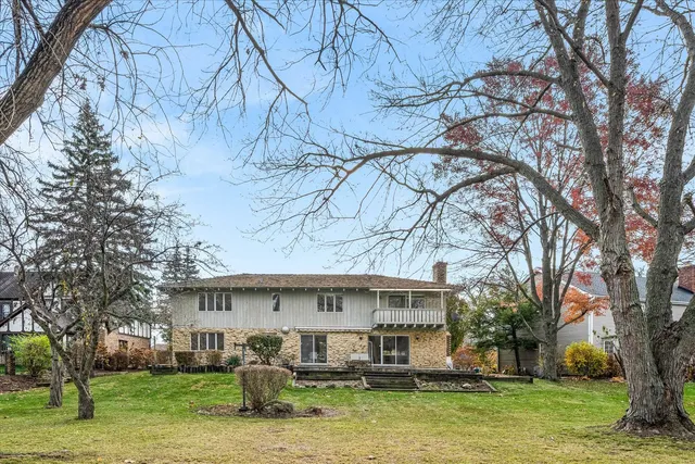a view of a house with pool and sitting area