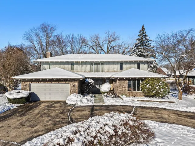a view of a white house with a yard and sitting area