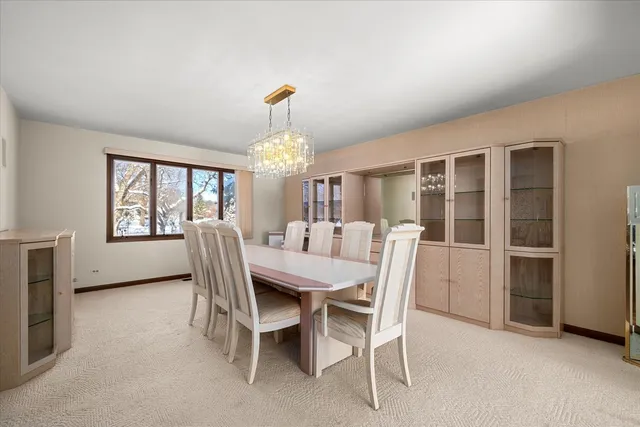 a view of a dining room with furniture and a chandelier
