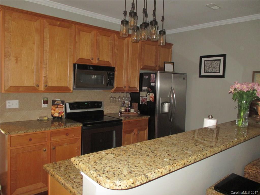 2147 Midnight Blue Lane, Unit 181 Fort Mill, SC 29708 - Photo 3 of 21 a kitchen with stainless steel appliances granite countertop a refrigerator a stove top oven a sink and dishwasher