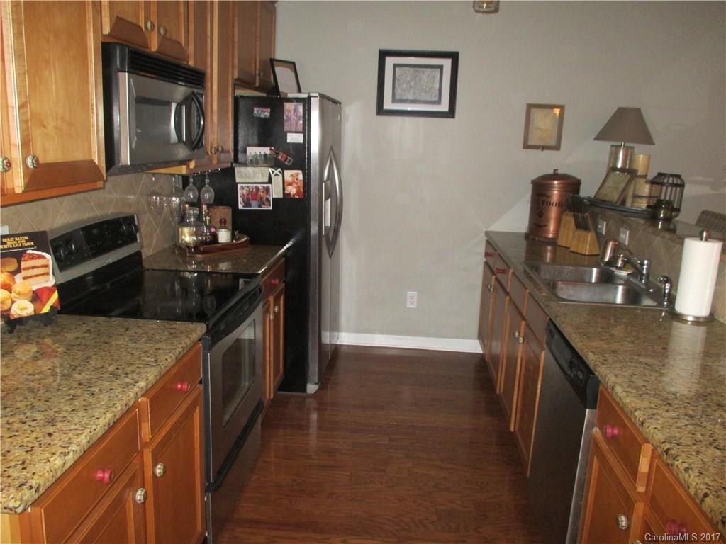 2147 Midnight Blue Lane, Unit 181 Fort Mill, SC 29708 - Photo 4 of 21 a kitchen with stainless steel appliances granite countertop a sink stove and refrigerator