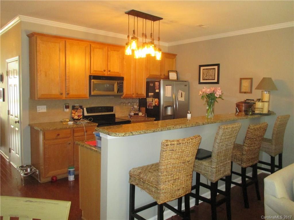 2147 Midnight Blue Lane, Unit 181 Fort Mill, SC 29708 - Photo 5 of 21 a view of a dining room with furniture and a chandelier