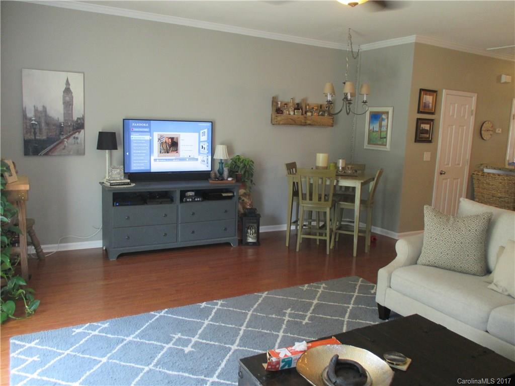 2147 Midnight Blue Lane, Unit 181 Fort Mill, SC 29708 - Photo 8 of 21 a living room with furniture a dining table and a potted plant