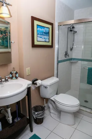 a bathroom with a toilet a sink and a mirror