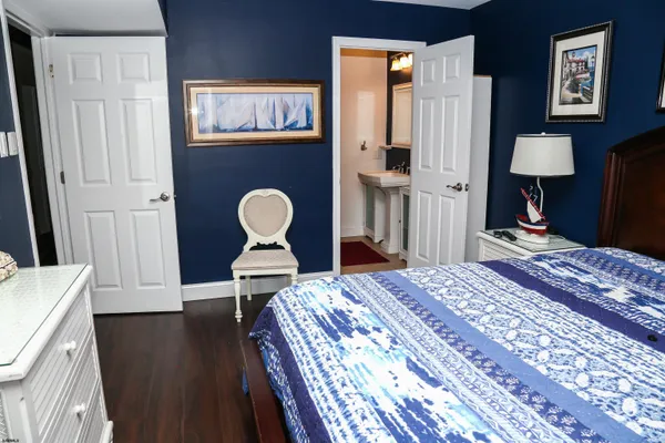 a bedroom with bed and wooden floor