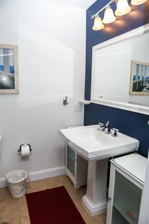 a bathroom with a sink toilet and mirror
