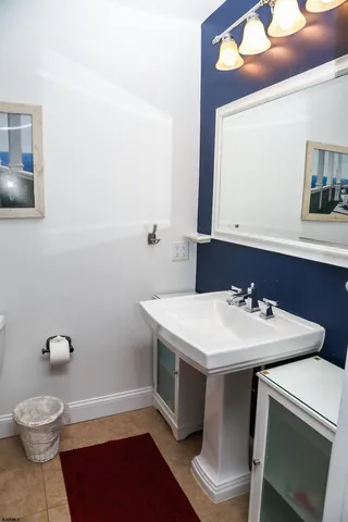 a bathroom with a sink toilet and mirror