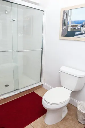 a white toilet sitting next to a bath tub and shower
