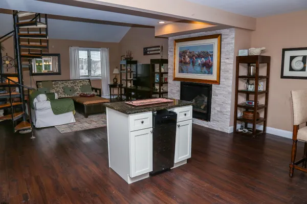 a view of a kitchen with furniture and wooden floor