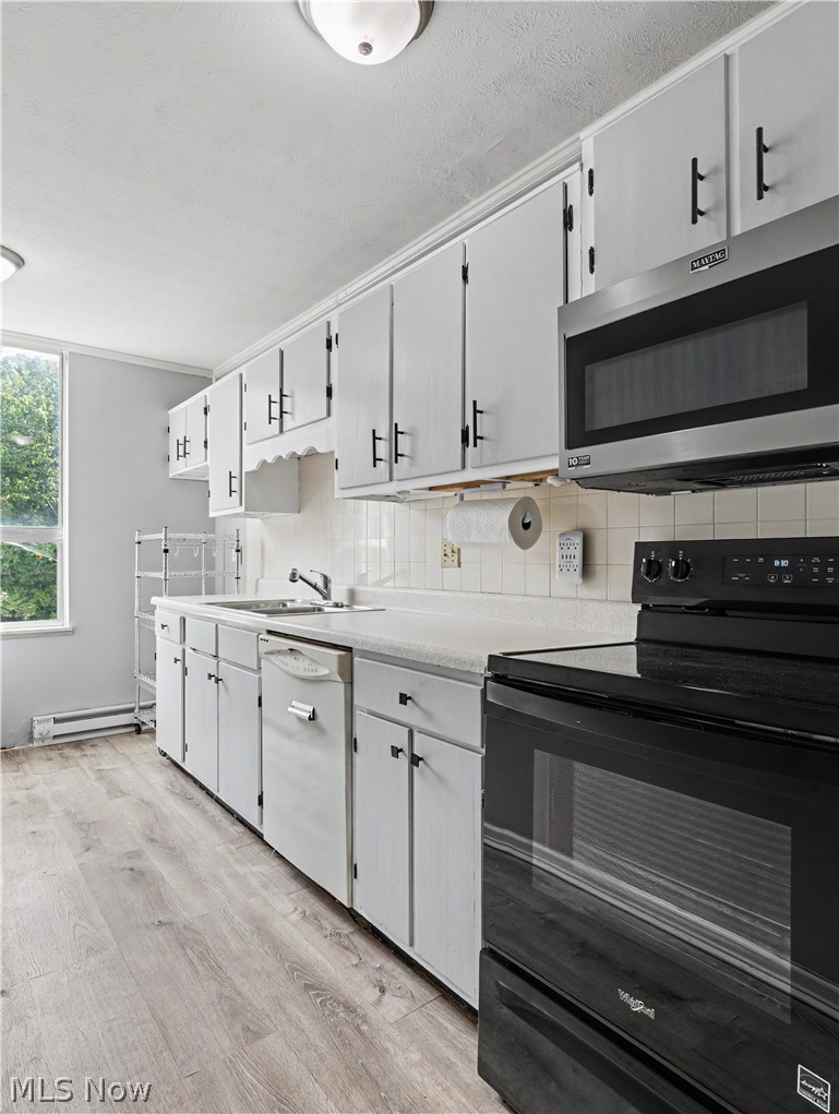 3064 Kent Road Stow, OH 44224 - Photo 6 of 30 Kitchen with wood-finish flooring, white cabinetry, and a black range
