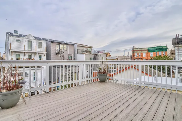 a view of a balcony with wooden floor