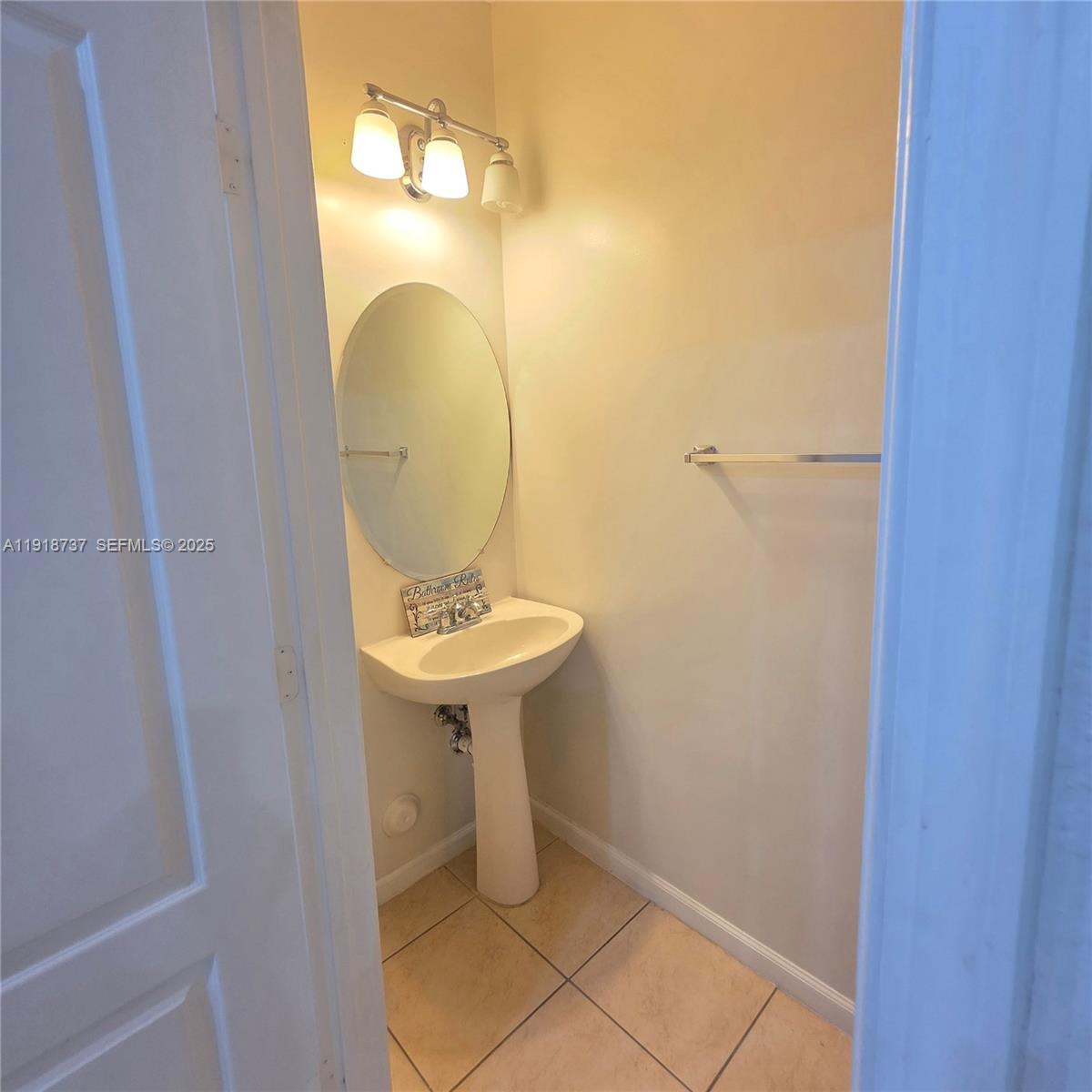 2612 Southwest 81st Terrace, Unit 206 Miramar, FL 33025 - Photo 11 of 40 a bathroom with a sink and mirror