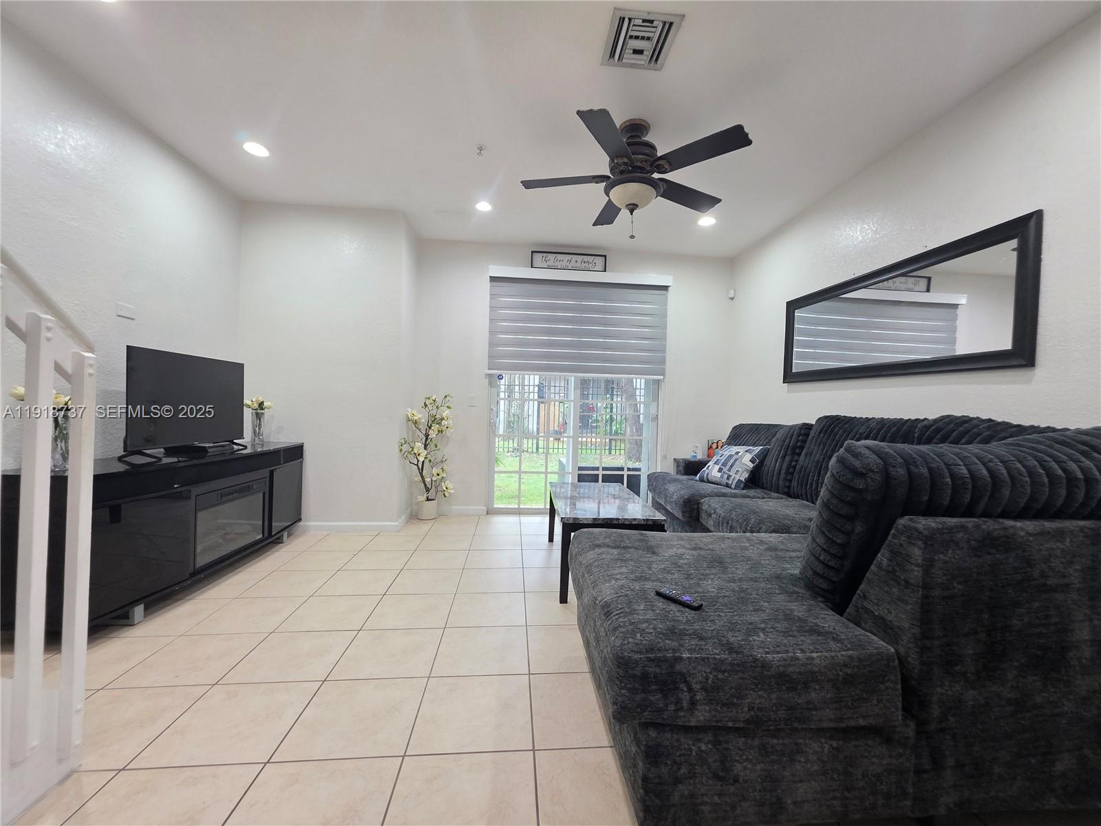 2612 Southwest 81st Terrace, Unit 206 Miramar, FL 33025 - Photo 13 of 40 a living room with furniture and a flat screen tv