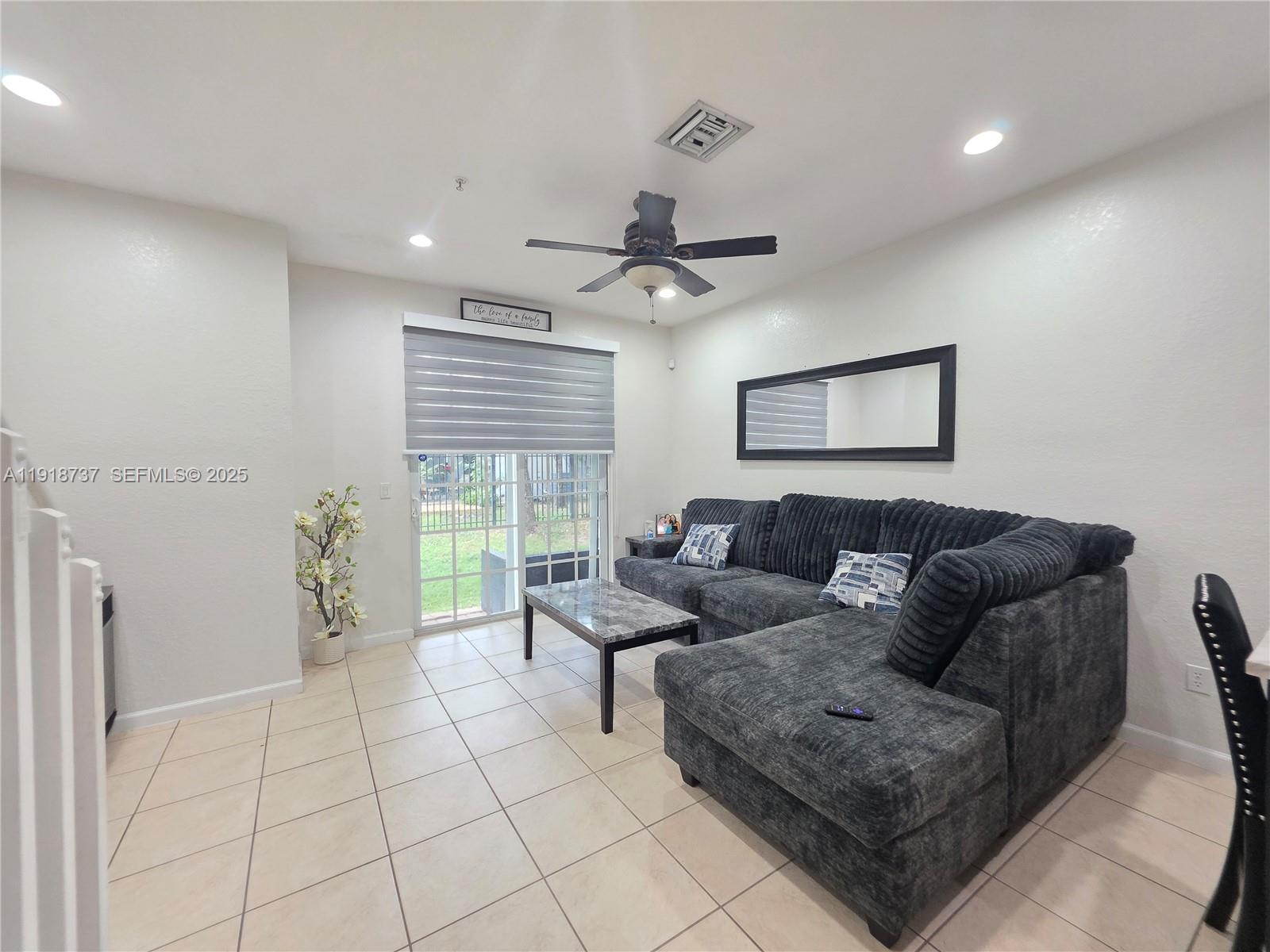2612 Southwest 81st Terrace, Unit 206 Miramar, FL 33025 - Photo 14 of 40 a living room with furniture and a large window