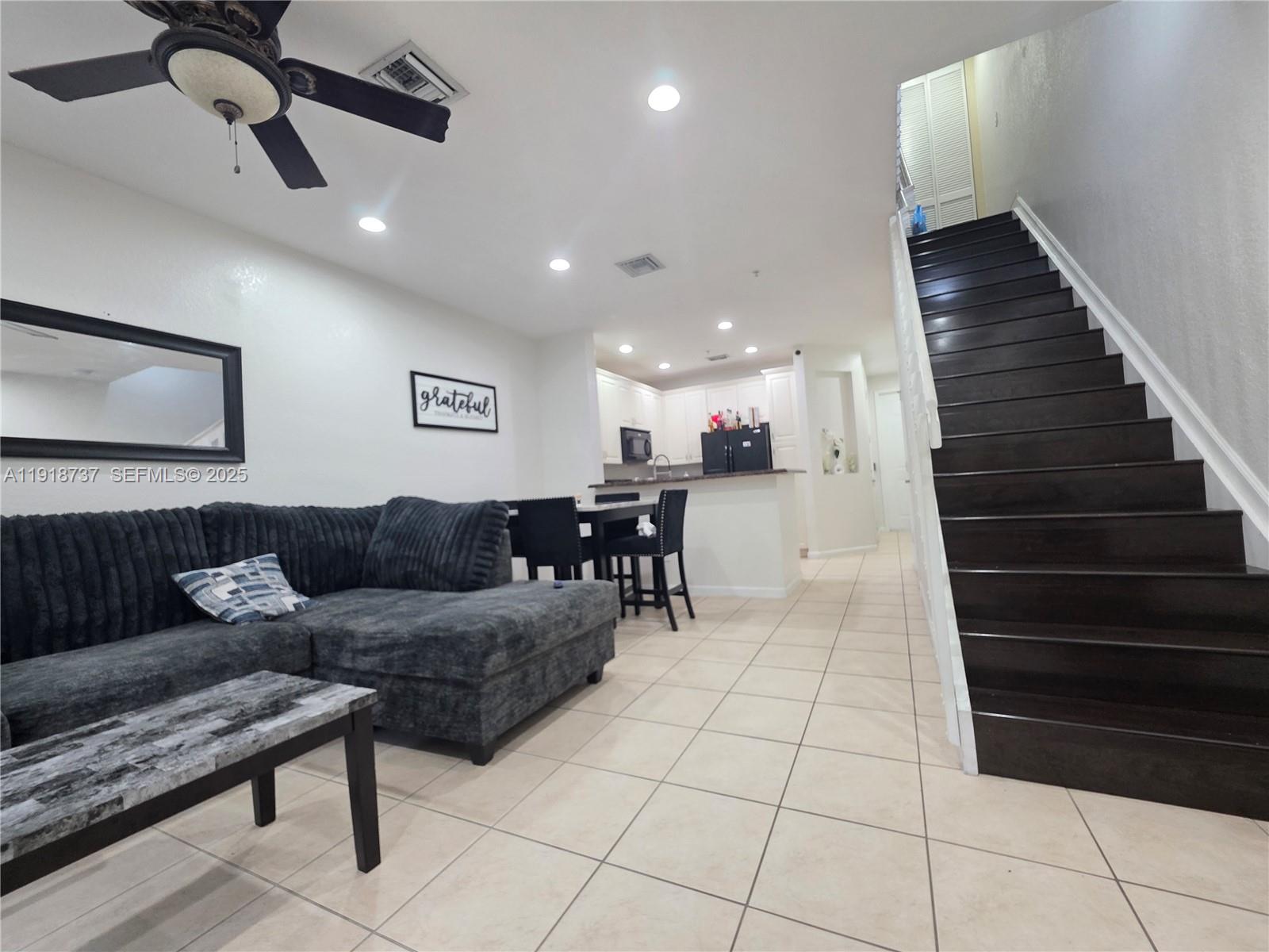 2612 Southwest 81st Terrace, Unit 206 Miramar, FL 33025 - Photo 15 of 40 a living room with furniture and a ceiling fan