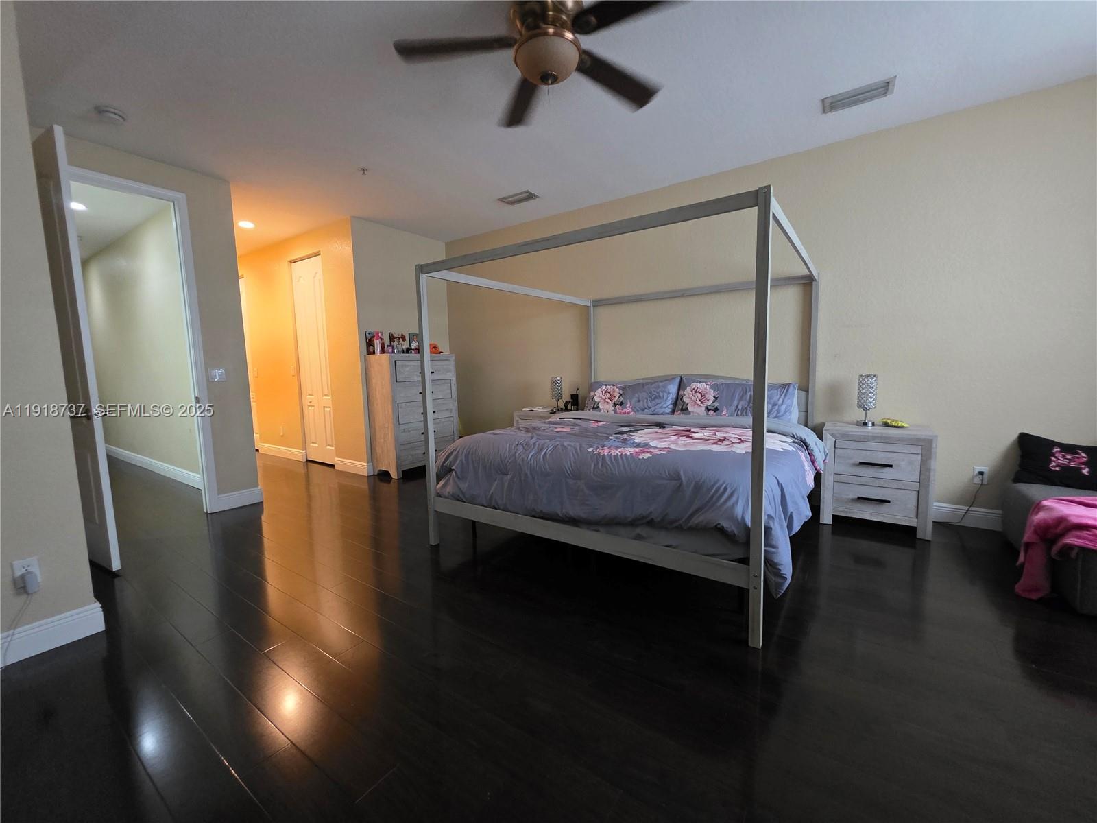 2612 Southwest 81st Terrace, Unit 206 Miramar, FL 33025 - Photo 19 of 40 a bedroom with a bed and wooden floor