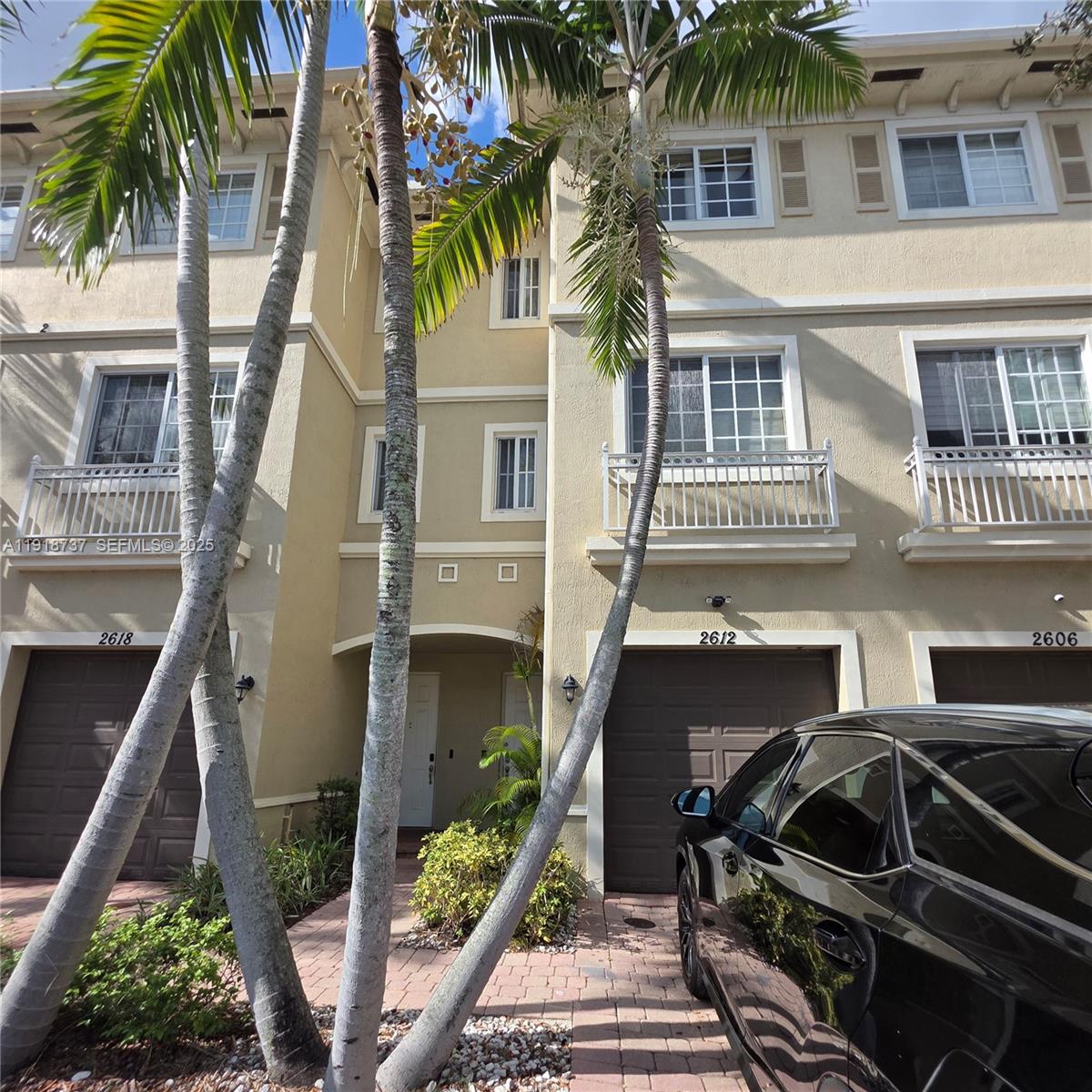 2612 Southwest 81st Terrace, Unit 206 Miramar, FL 33025 - Photo 2 of 40 a front view of a house with a yard