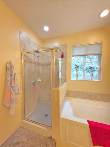 a bathroom with a bathtub and a shower