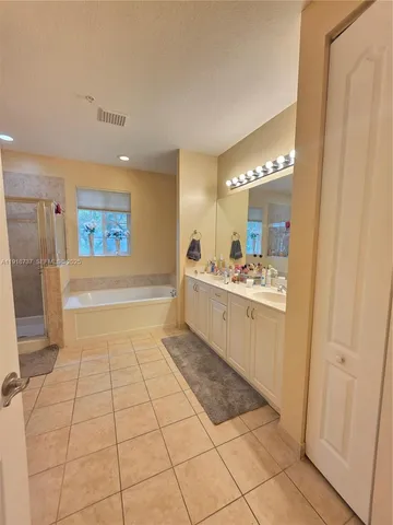 a bathroom with a sink a mirror and a bathtub