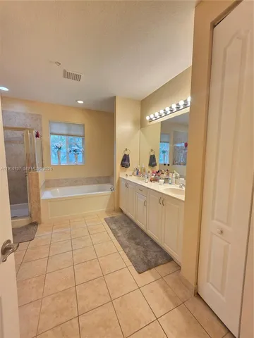 a bathroom with a sink a mirror and a bathtub