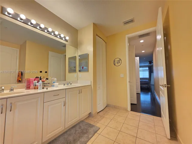 a bathroom with a double vanity sink and a mirror