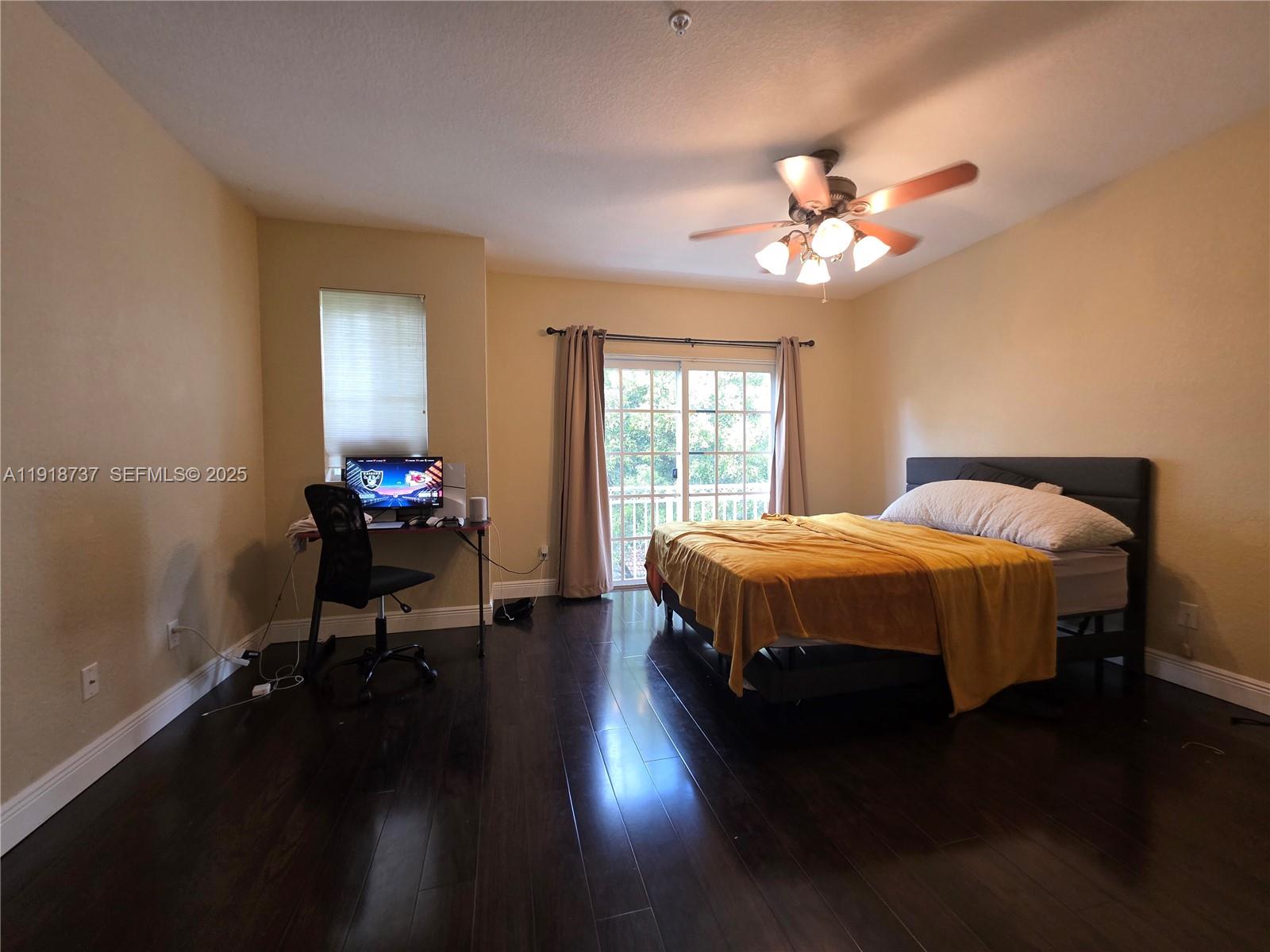 2612 Southwest 81st Terrace, Unit 206 Miramar, FL 33025 - Photo 30 of 40 a bed sitting in a bedroom next to a window