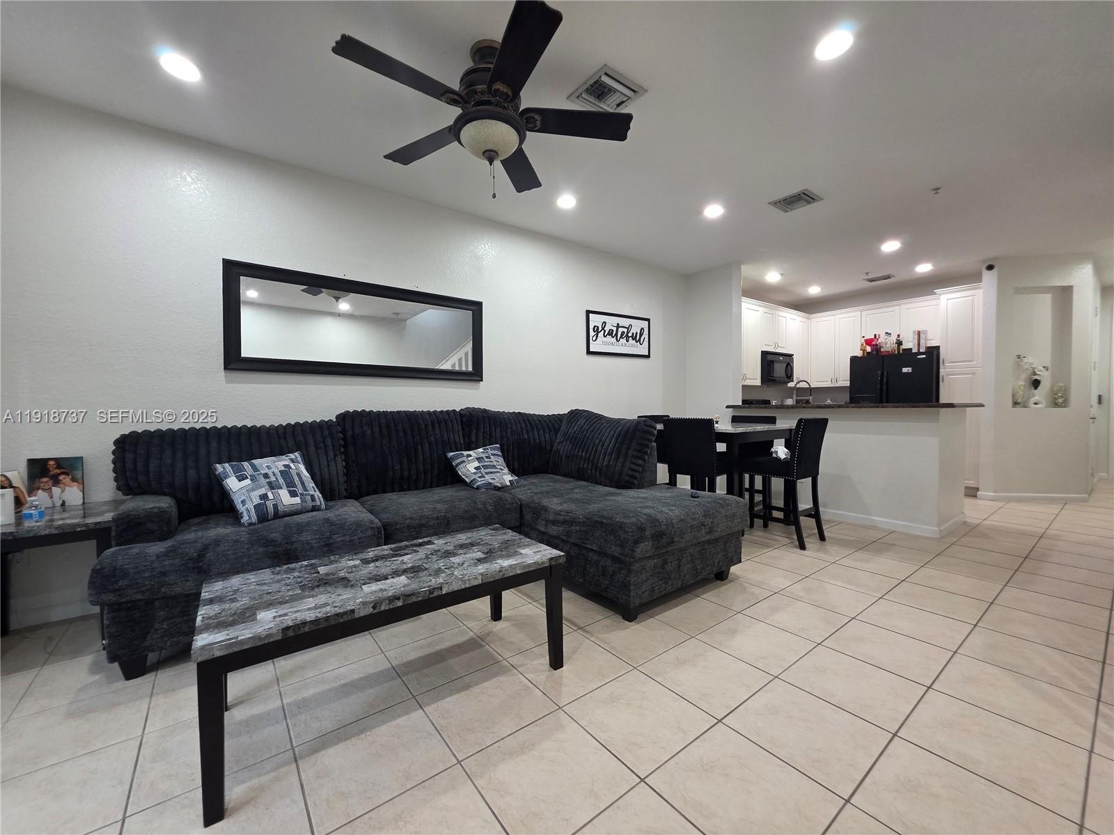2612 Southwest 81st Terrace, Unit 206 Miramar, FL 33025 - Photo 3 of 40 a living room with furniture and kitchen view