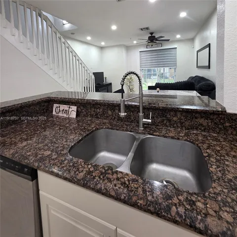 a kitchen with a sink and a refrigerator