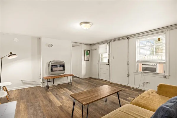 a living room with furniture a rug and a window