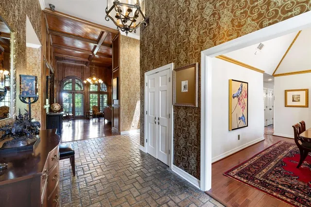 a living room with fireplace furniture and a chandelier